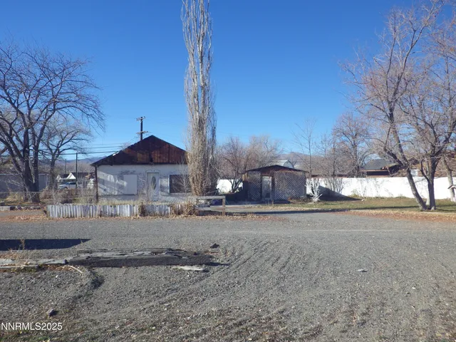 a front view of a house with a yard and covered with snow
