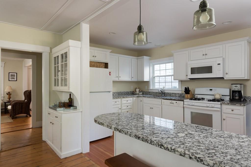 316 Lower County Road Harwich, MA 02646 - Photo 11 of 29 a kitchen with kitchen island granite countertop a sink cabinets and window