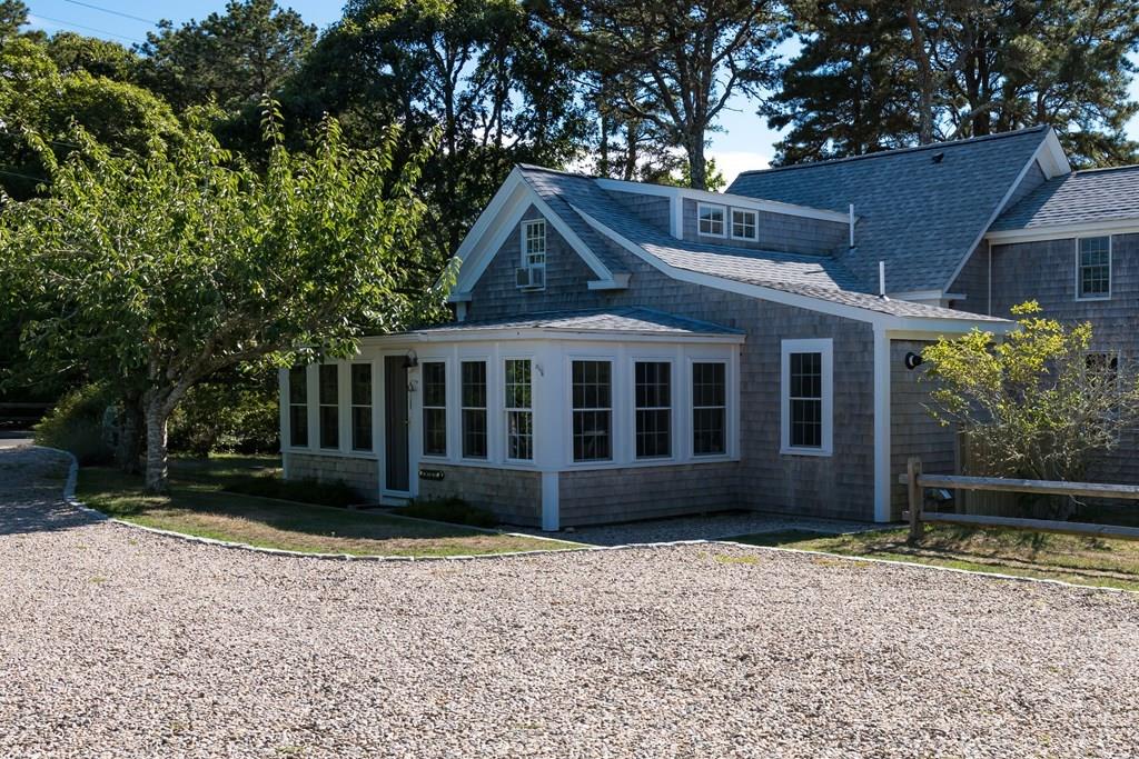 316 Lower County Road Harwich, MA 02646 - Photo 2 of 29 a front view of a house with a garden