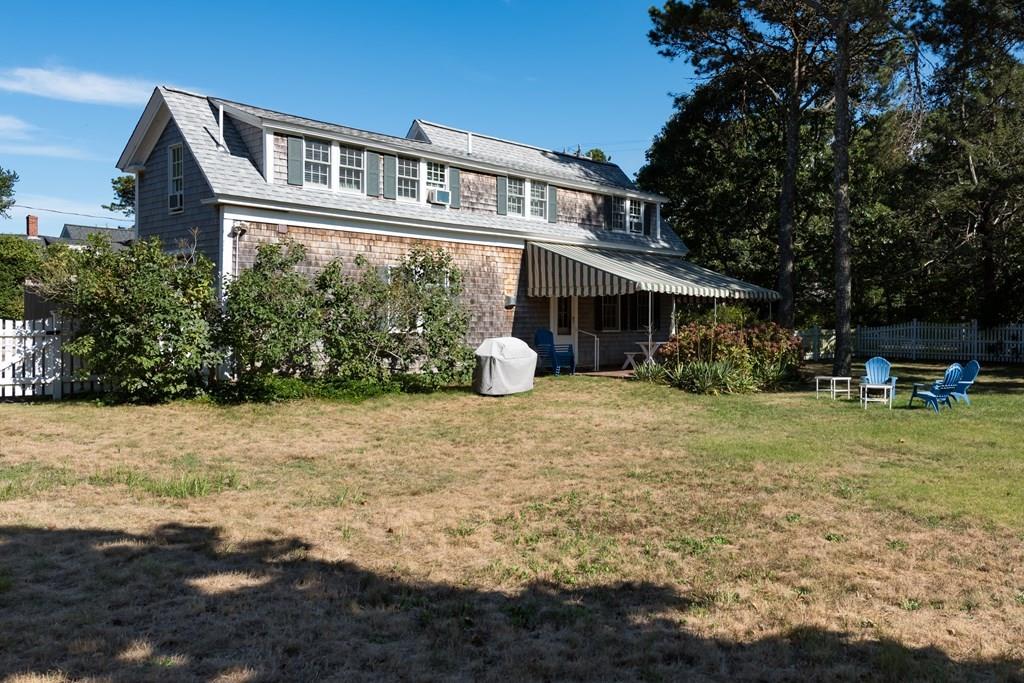 316 Lower County Road Harwich, MA 02646 - Photo 5 of 29 a front view of a house with a yard