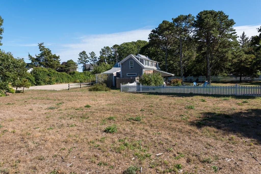 316 Lower County Road Harwich, MA 02646 - Photo 6 of 29 a backyard of a house with lots of green space
