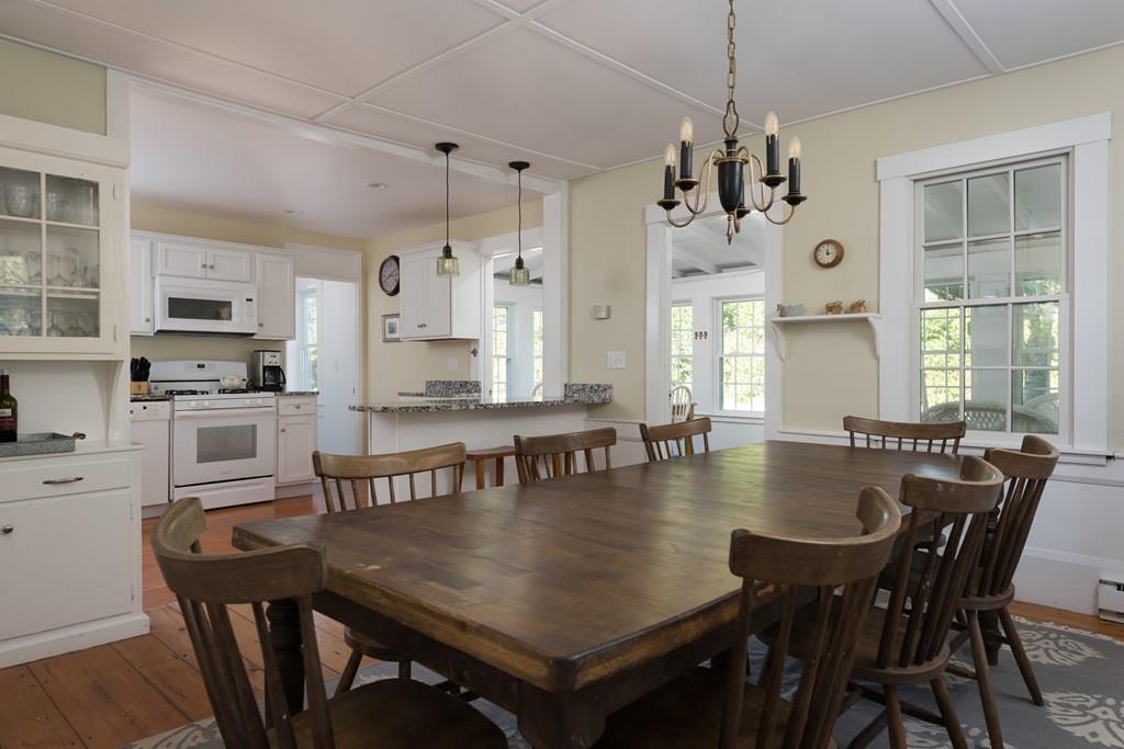 316 Lower County Road Harwich, MA 02646 - Photo 9 of 29 a view of a dining room and livingroom with furniture window and wooden floor