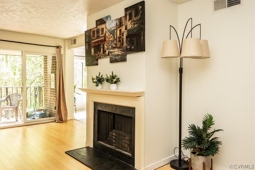 1507 Largo Road, Unit 303 Henrico, VA 23238 - Photo 7 of 40 Living room with a textured ceiling and hardwood /