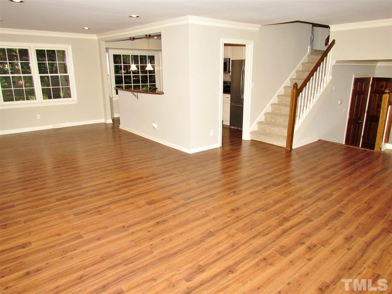 212 Dunstable Court Raleigh, NC 27614 - Photo 3 of 25 a view of an empty room with wooden floor and windows