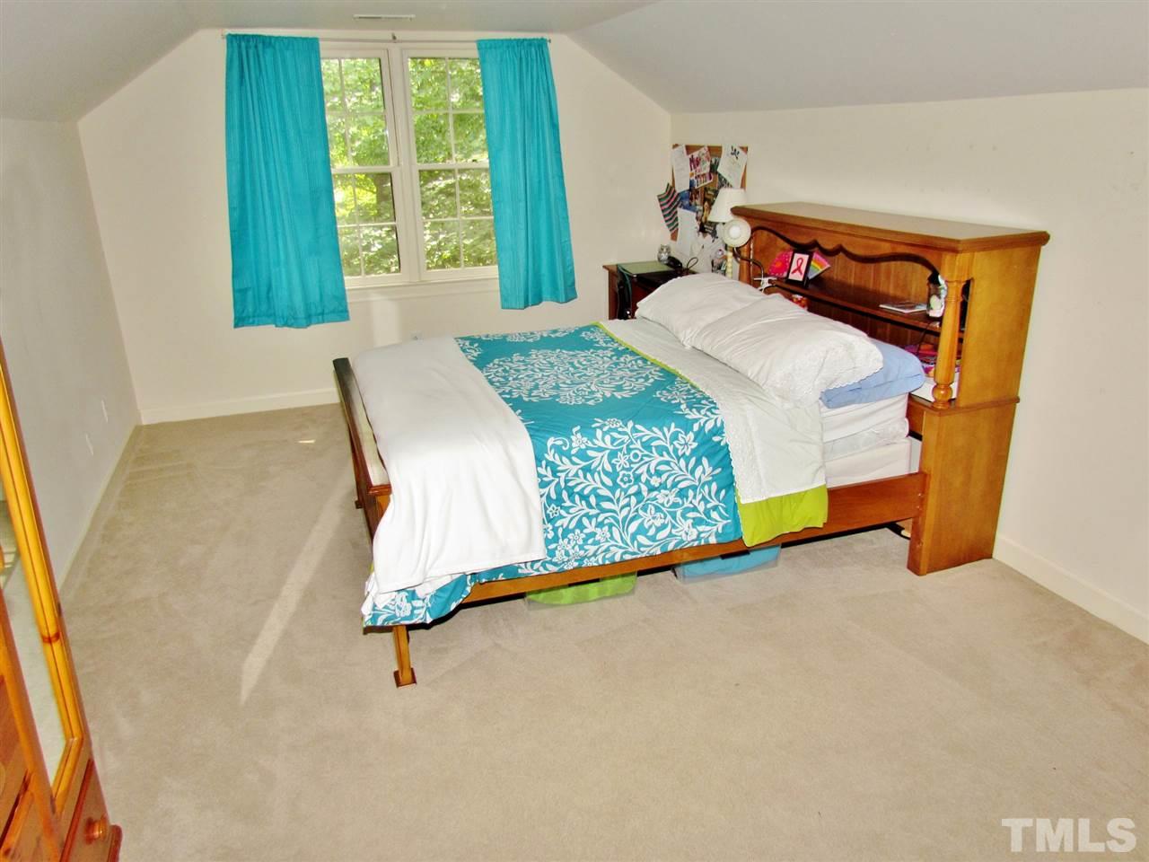 212 Dunstable Court Raleigh, NC 27614 - Photo 21 of 25 a bedroom with a bed and a window