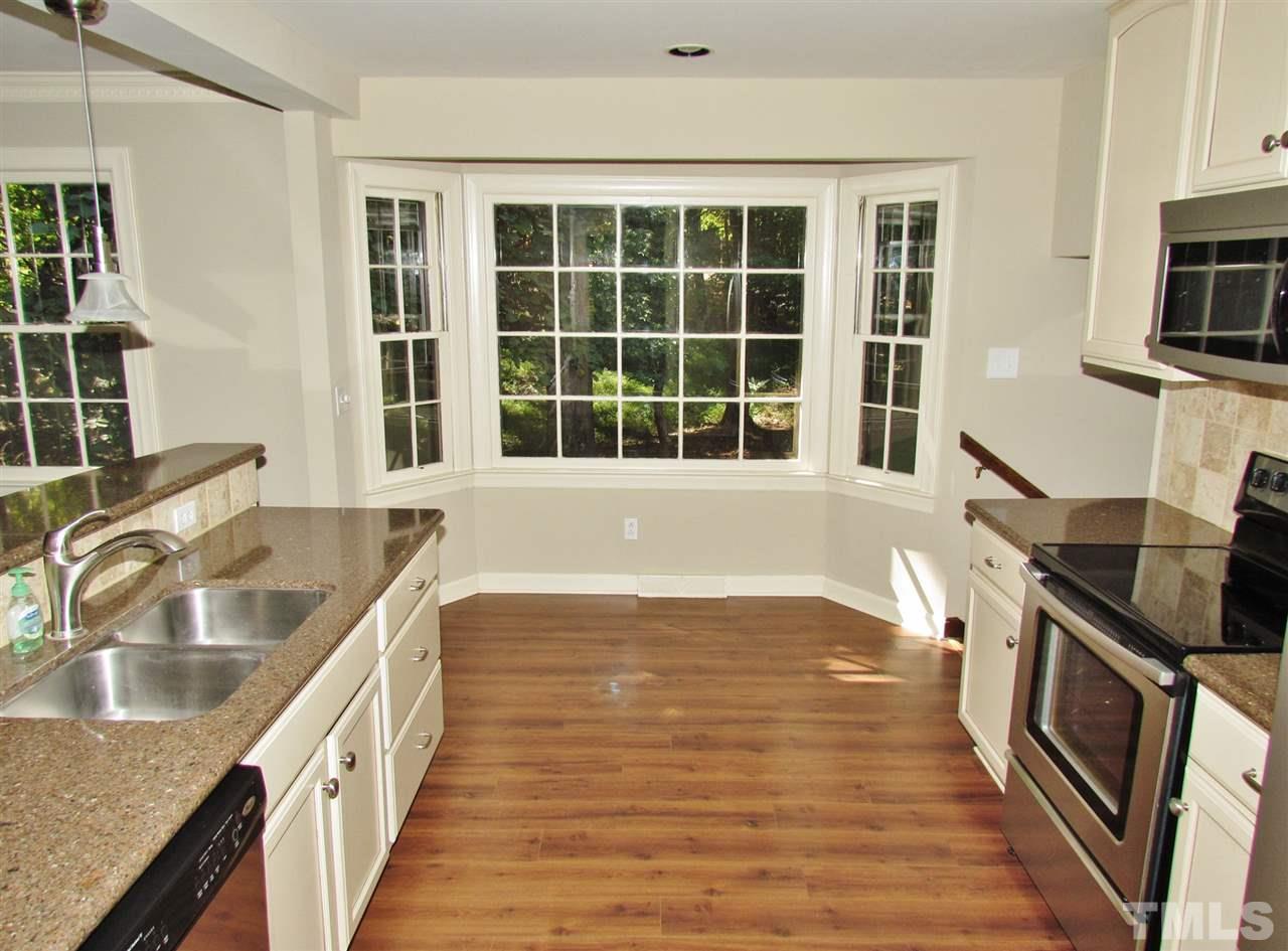 212 Dunstable Court Raleigh, NC 27614 - Photo 8 of 25 a kitchen with granite countertop a sink and a stove top oven