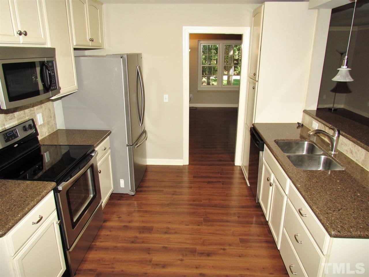 212 Dunstable Court Raleigh, NC 27614 - Photo 10 of 25 a kitchen with granite countertop a stove and a refrigerator