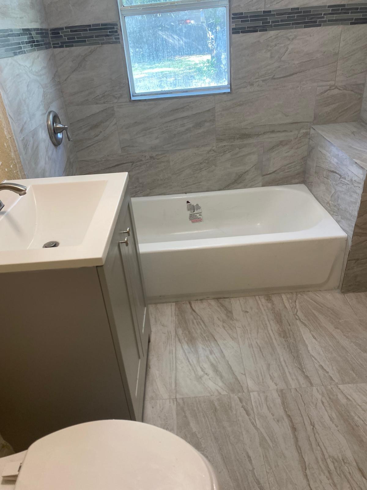 143 North 15th Street Fort Pierce, FL 34950 - Photo 2 of 5 a bathroom with a sink a toilet a bathtub and shower