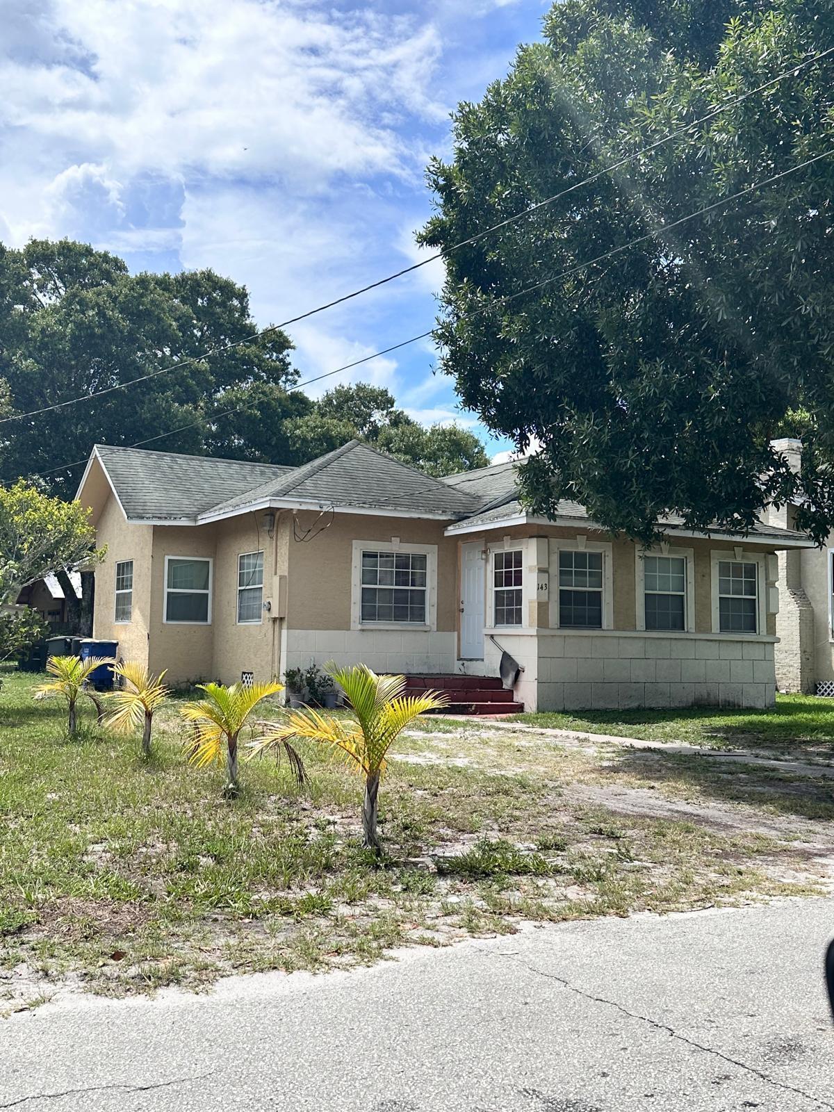 143 North 15th Street Fort Pierce, FL 34950 - Photo 5 of 5 a view of a house with a big yard and large trees