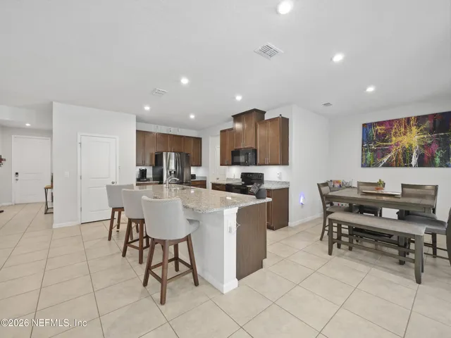 a living room with furniture a dining table and kitchen view