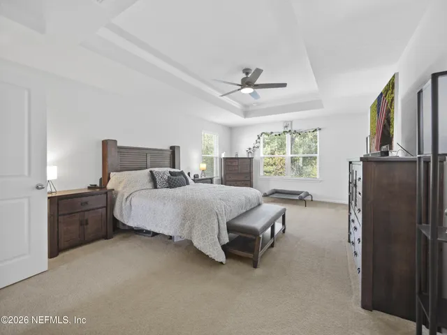 a bed room with a bed furniture and a large window