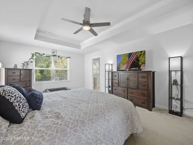 a bedroom with a bed dresser and a window