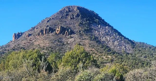 a view of a large mountain with a mountain in the background