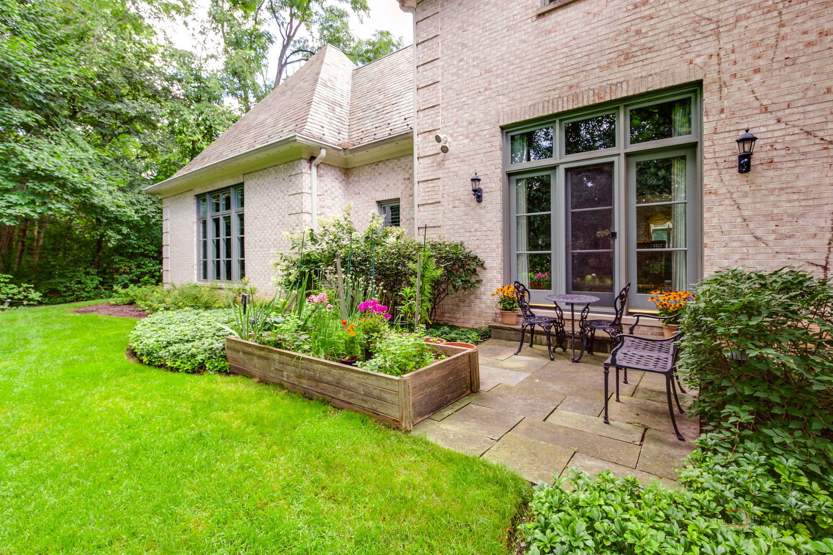 1271 North Green Bay Road Lake Forest, IL 60045 - Photo 50 of 57 a view of a house with backyard sitting area and garden