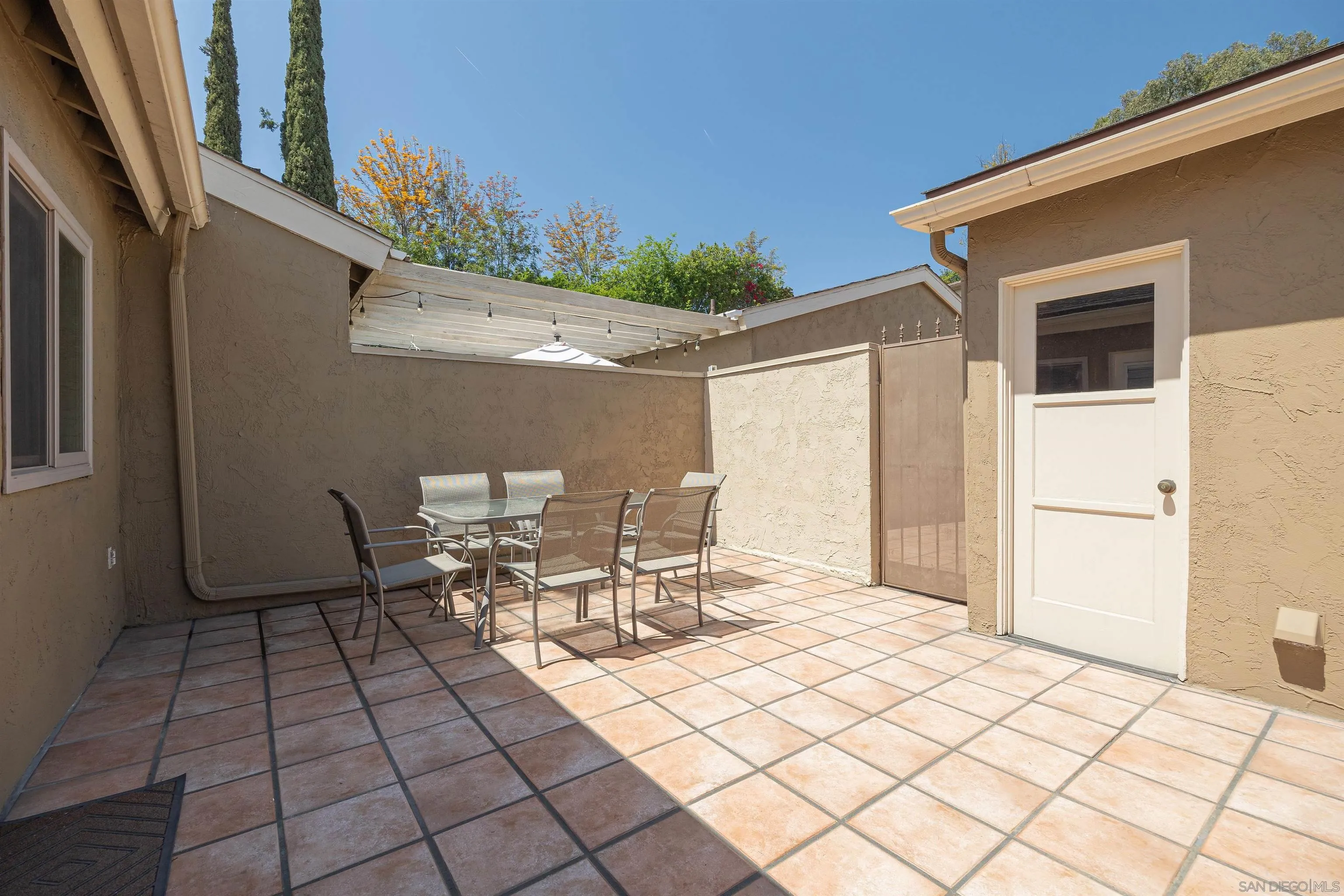 7700 Parkway Drive, Unit 4 La Mesa, CA 91942 - Photo 18 of 23 a view of a patio with table and chairs and potted plants