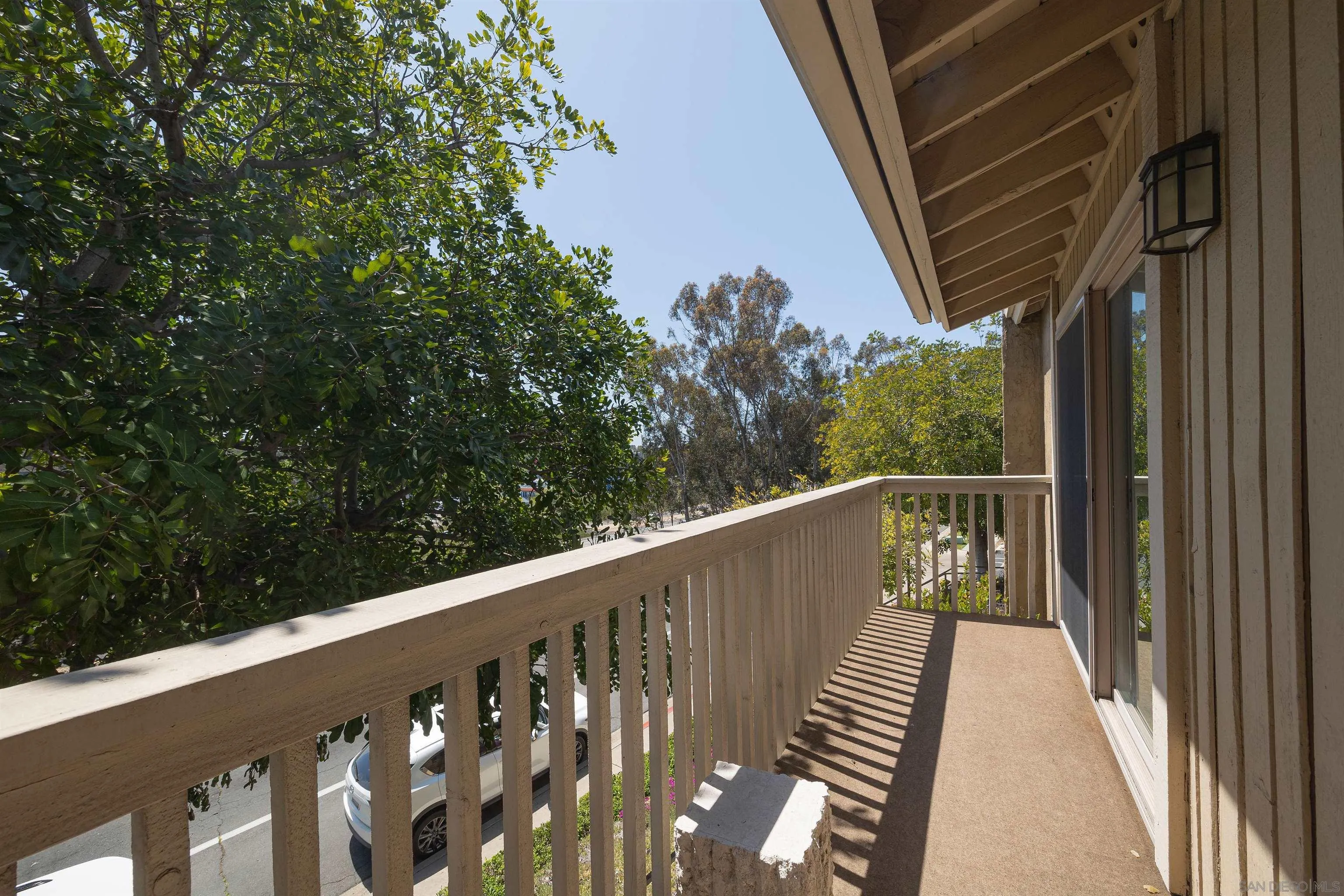 7700 Parkway Drive, Unit 4 La Mesa, CA 91942 - Photo 20 of 23 a view of balcony with wooden floor and fence