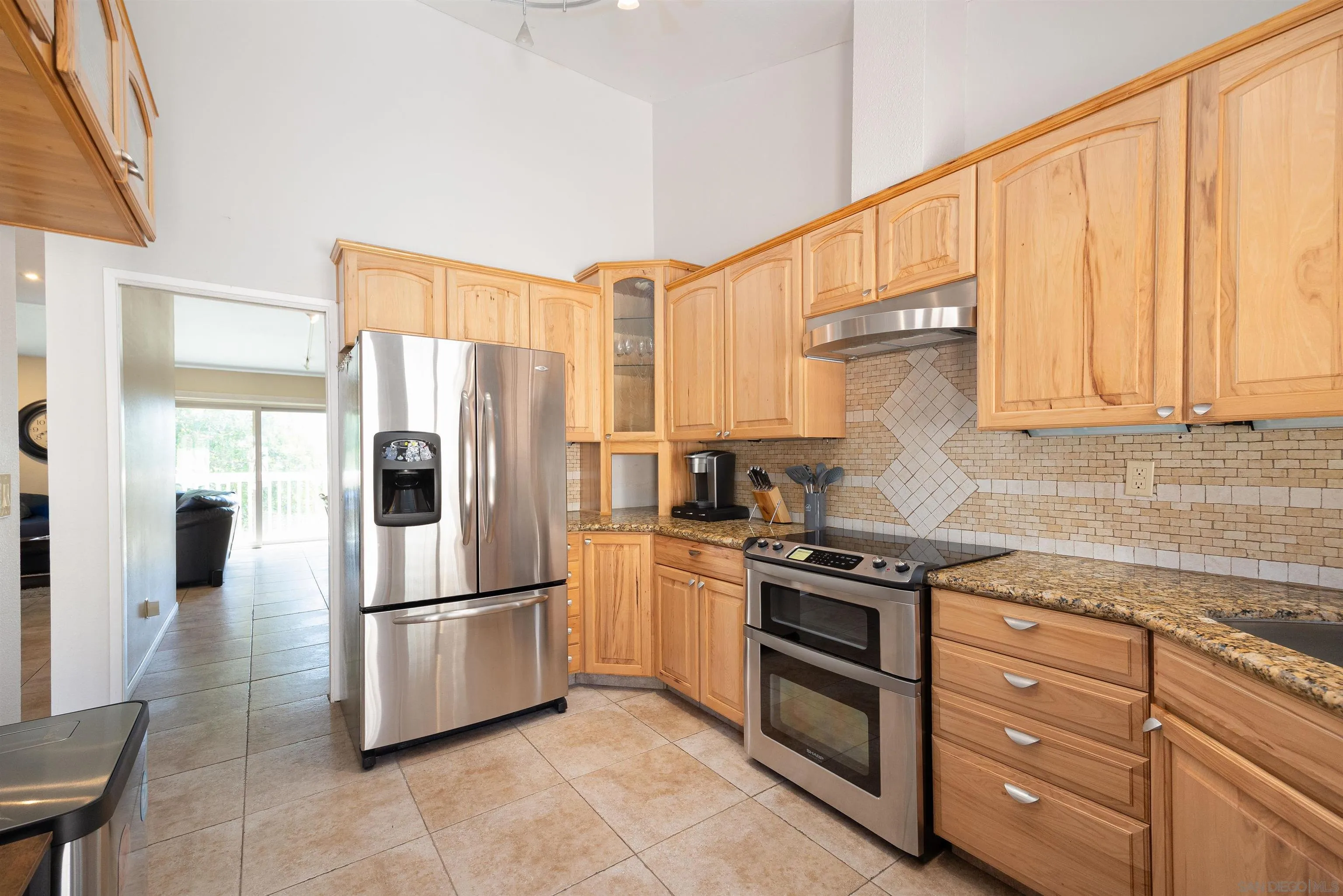 7700 Parkway Drive, Unit 4 La Mesa, CA 91942 - Photo 2 of 23 a kitchen with stainless steel appliances granite countertop a refrigerator a stove and a sink