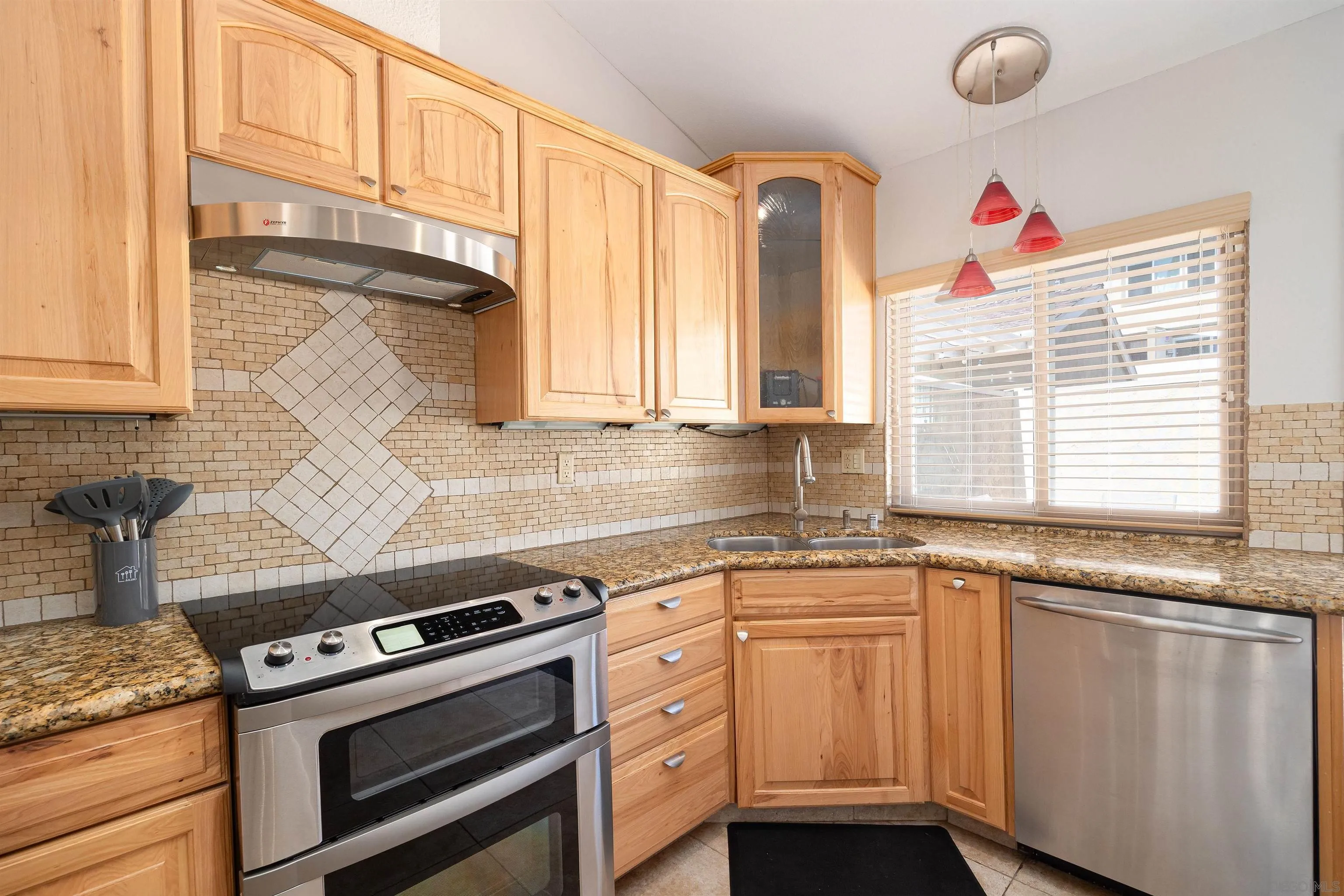 7700 Parkway Drive, Unit 4 La Mesa, CA 91942 - Photo 4 of 23 a kitchen with granite countertop a sink stainless steel appliances and cabinets