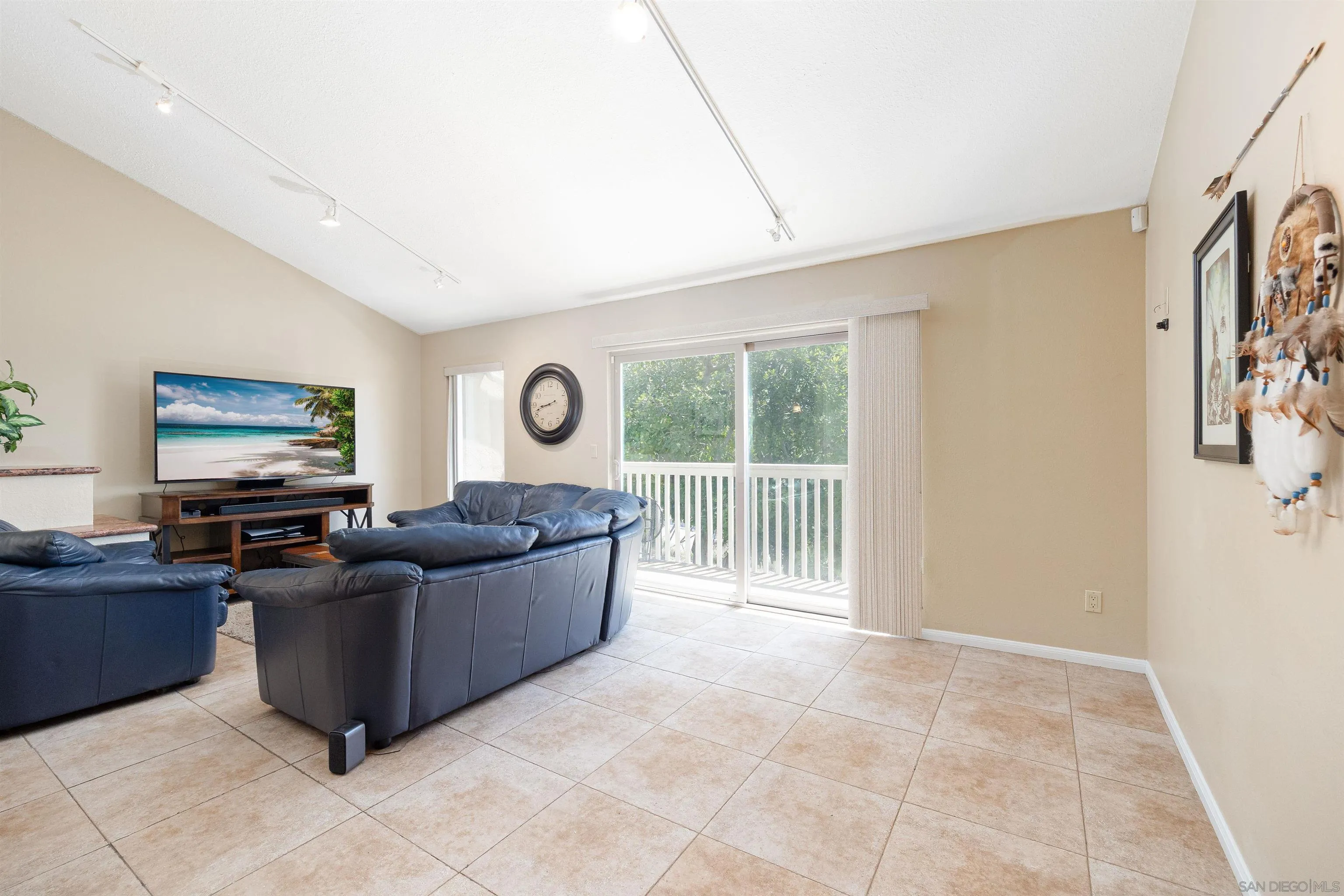 7700 Parkway Drive, Unit 4 La Mesa, CA 91942 - Photo 8 of 23 a living room with furniture and a flat screen tv