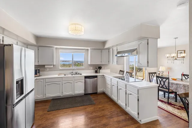 a kitchen with white cabinets and white appliances