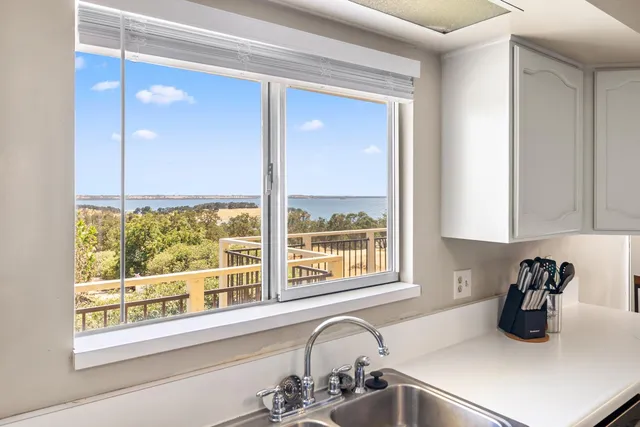 a kitchen with a sink a counter top and a window