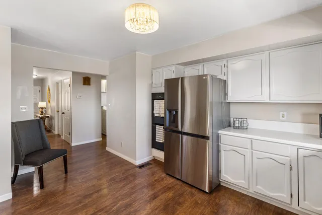 a kitchen with stainless steel appliances granite countertop a refrigerator and a stove top oven