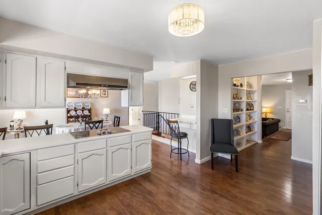 a room with white cabinets and wooden floor