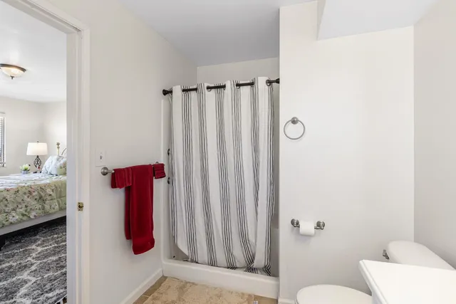 a bathroom with a shower curtain and a sink