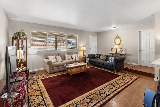 a living room with furniture rug and window