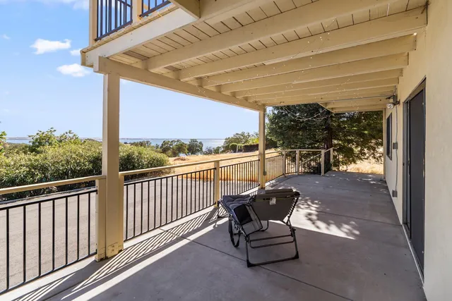 a view of balcony with couch and chairs