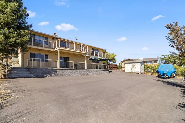 a front view of a house with a yard and balcony