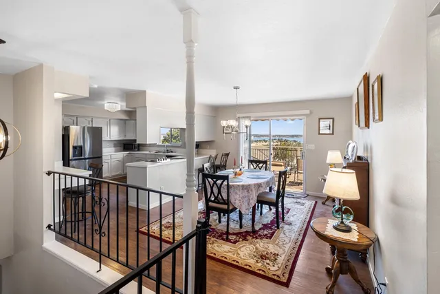 a living room with furniture a rug and a table