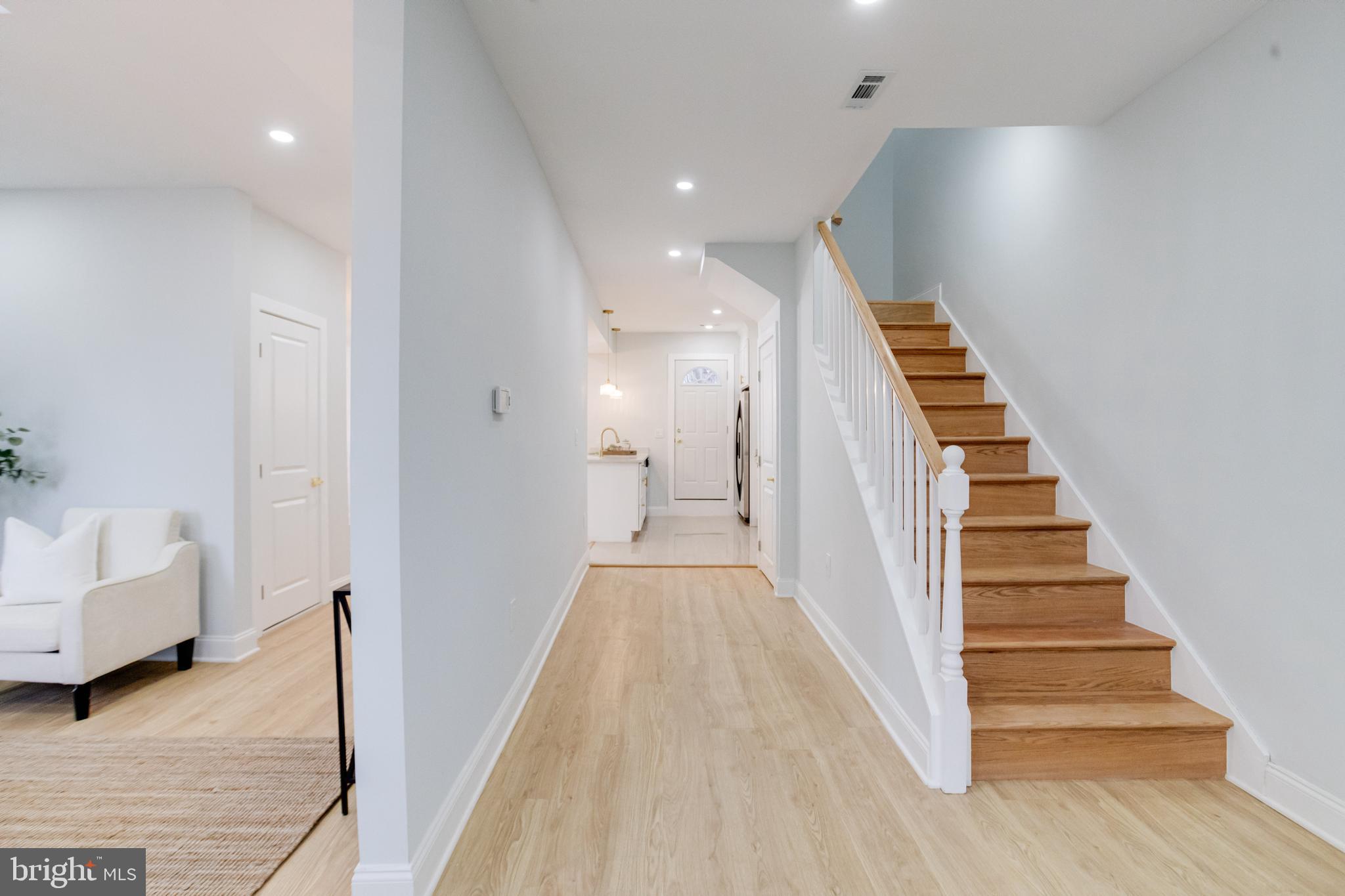 635 North Rosedale Street Baltimore, MD 21216 - Photo 16 of 64 a view of a hallway with stairs and a couch