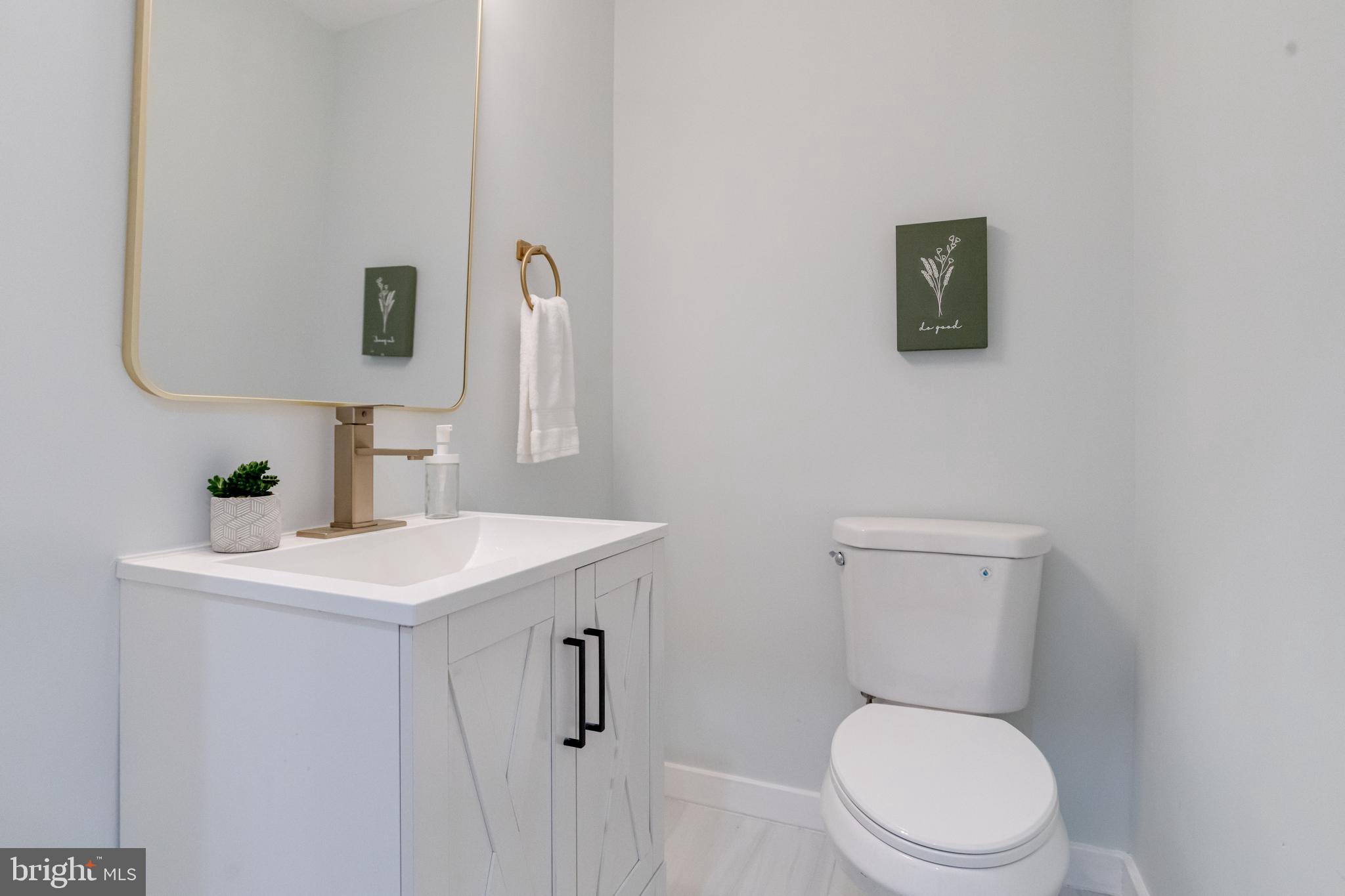 635 North Rosedale Street Baltimore, MD 21216 - Photo 26 of 64 a white toilet sitting next to a bathroom sink