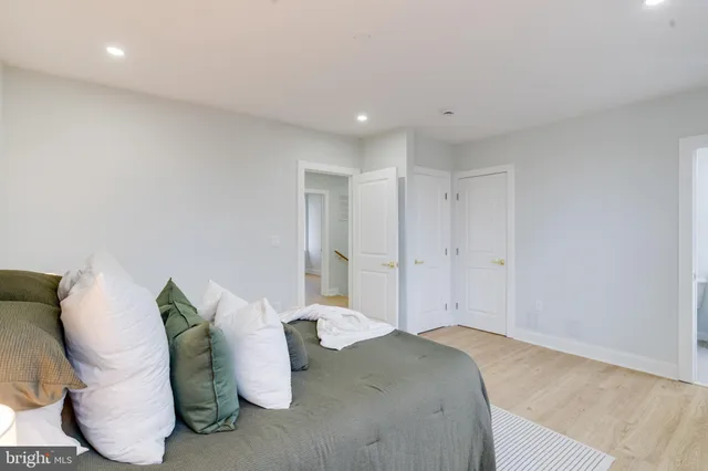 a bedroom with bed and wooden floor
