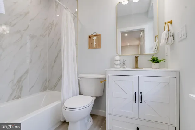 a bedroom with a bed and a wall painting