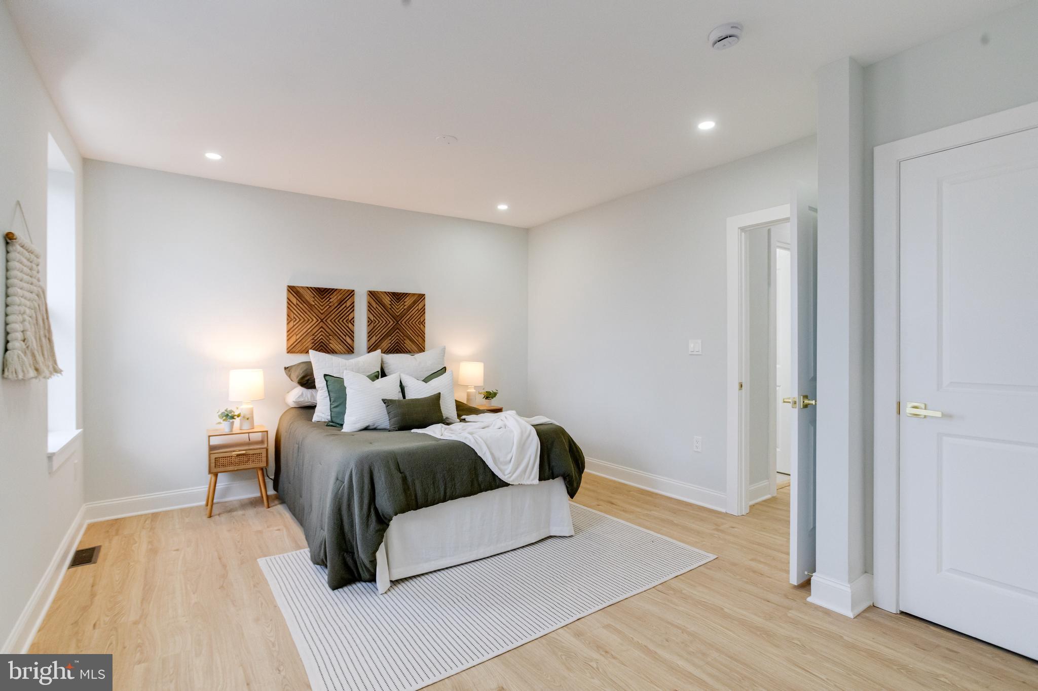 635 North Rosedale Street Baltimore, MD 21216 - Photo 30 of 64 a bedroom with a bed and wooden floor