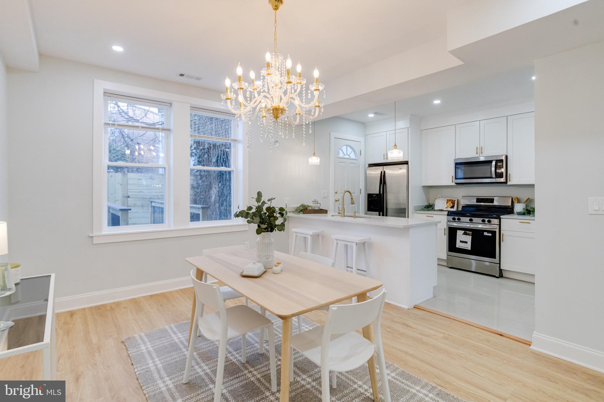 635 North Rosedale Street Baltimore, MD 21216 - Photo 3 of 64 a kitchen that has a lot of white cabinets and stainless steel appliances