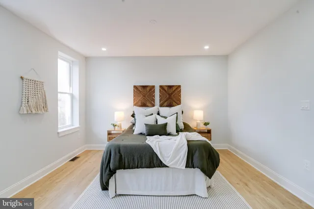 a bathroom with a sink vanity mirror and toilet
