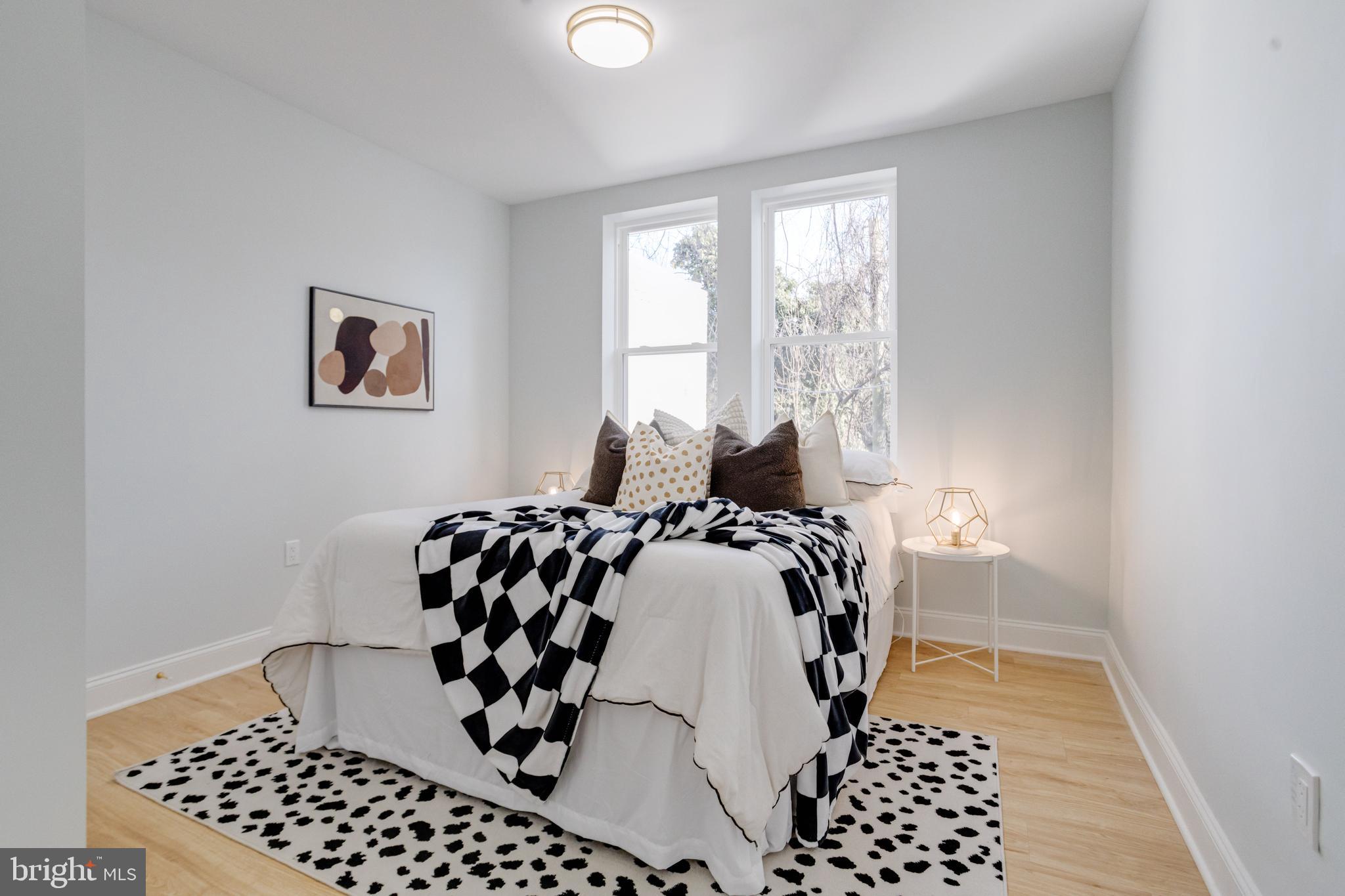 635 North Rosedale Street Baltimore, MD 21216 - Photo 34 of 64 a bedroom with bed and wooden floor