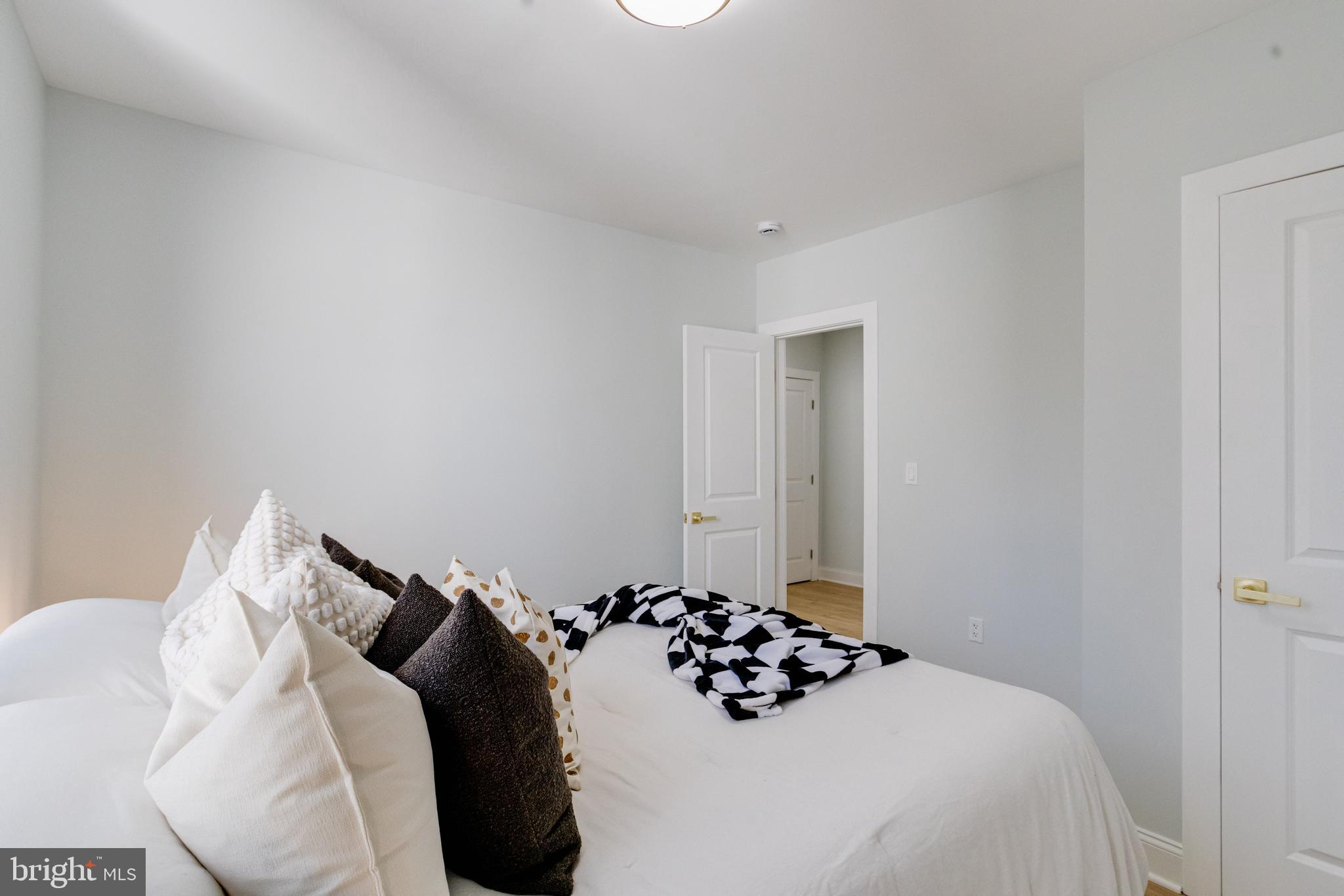 635 North Rosedale Street Baltimore, MD 21216 - Photo 35 of 64 a bedroom with a bed and a wall painting