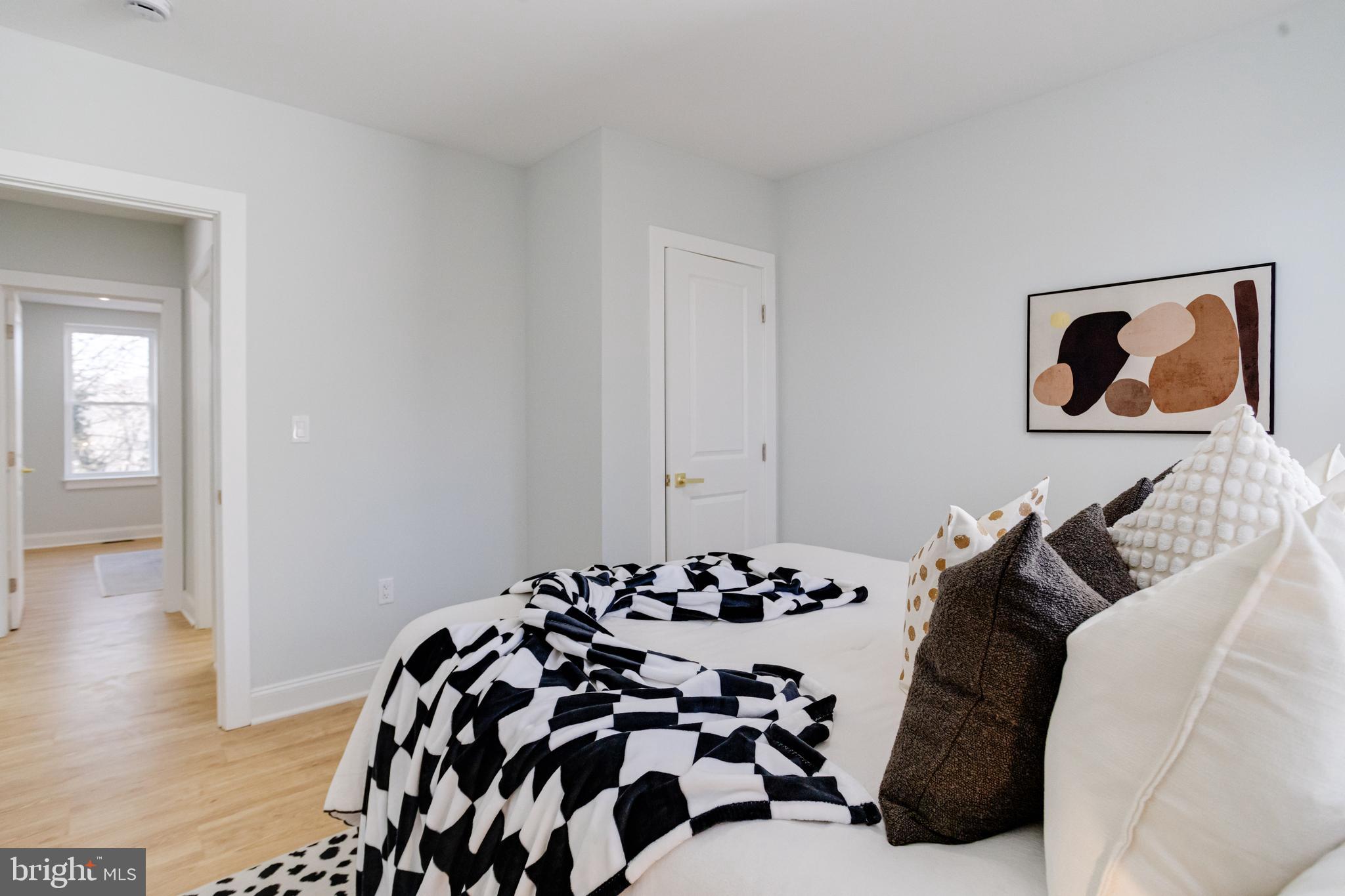 635 North Rosedale Street Baltimore, MD 21216 - Photo 36 of 64 a bedroom with a bed and wooden floor
