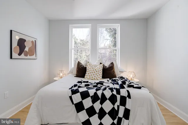 a bathroom with a toilet sink vanity and mirror
