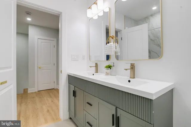 a bathroom with a toilet a sink and mirror