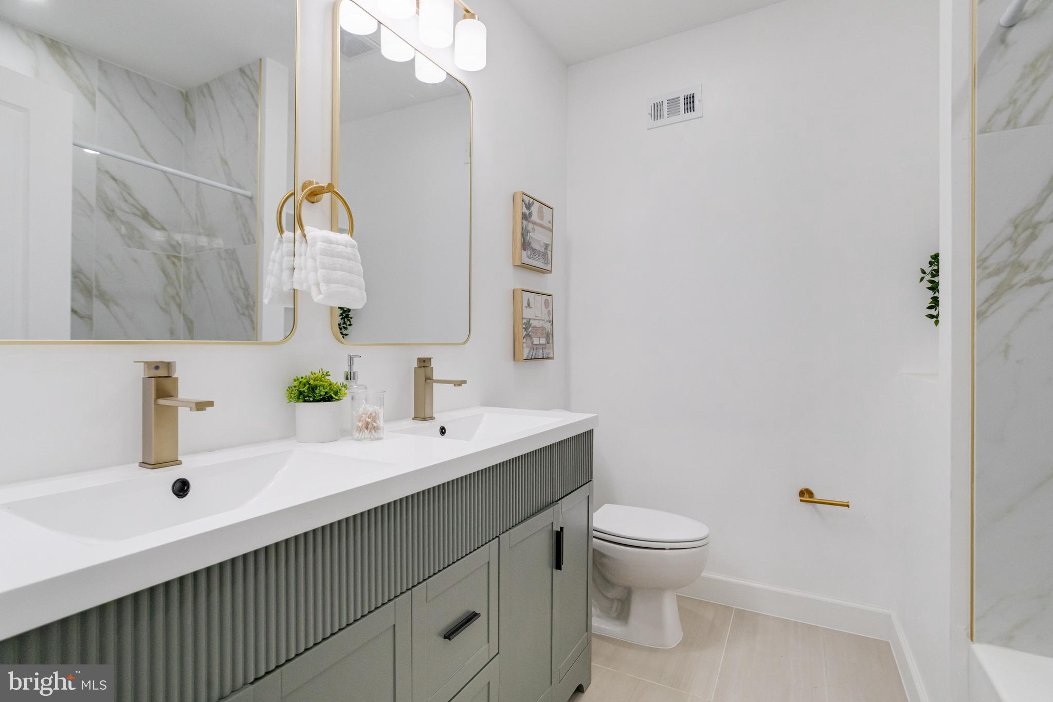 635 North Rosedale Street Baltimore, MD 21216 - Photo 39 of 64 a bathroom with a sink vanity mirror and toilet