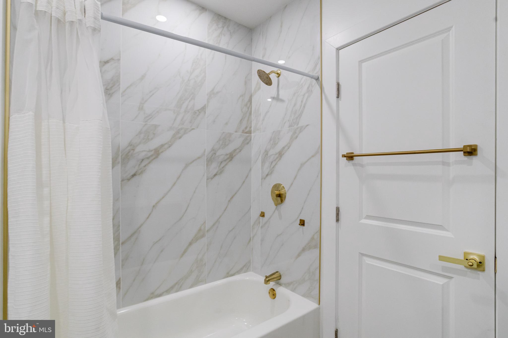 635 North Rosedale Street Baltimore, MD 21216 - Photo 42 of 64 a bathroom with a shower and a tub