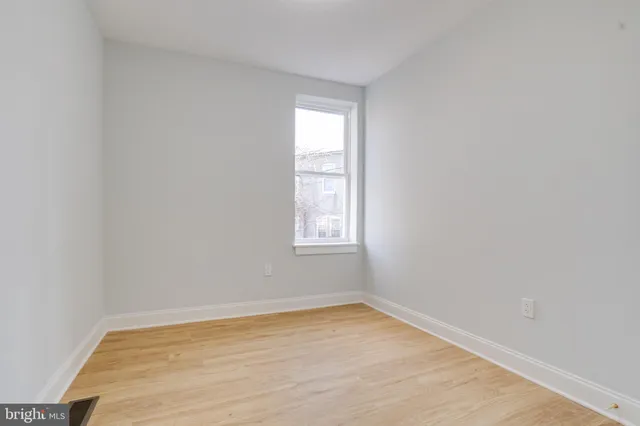 a view of a street with wooden fence
