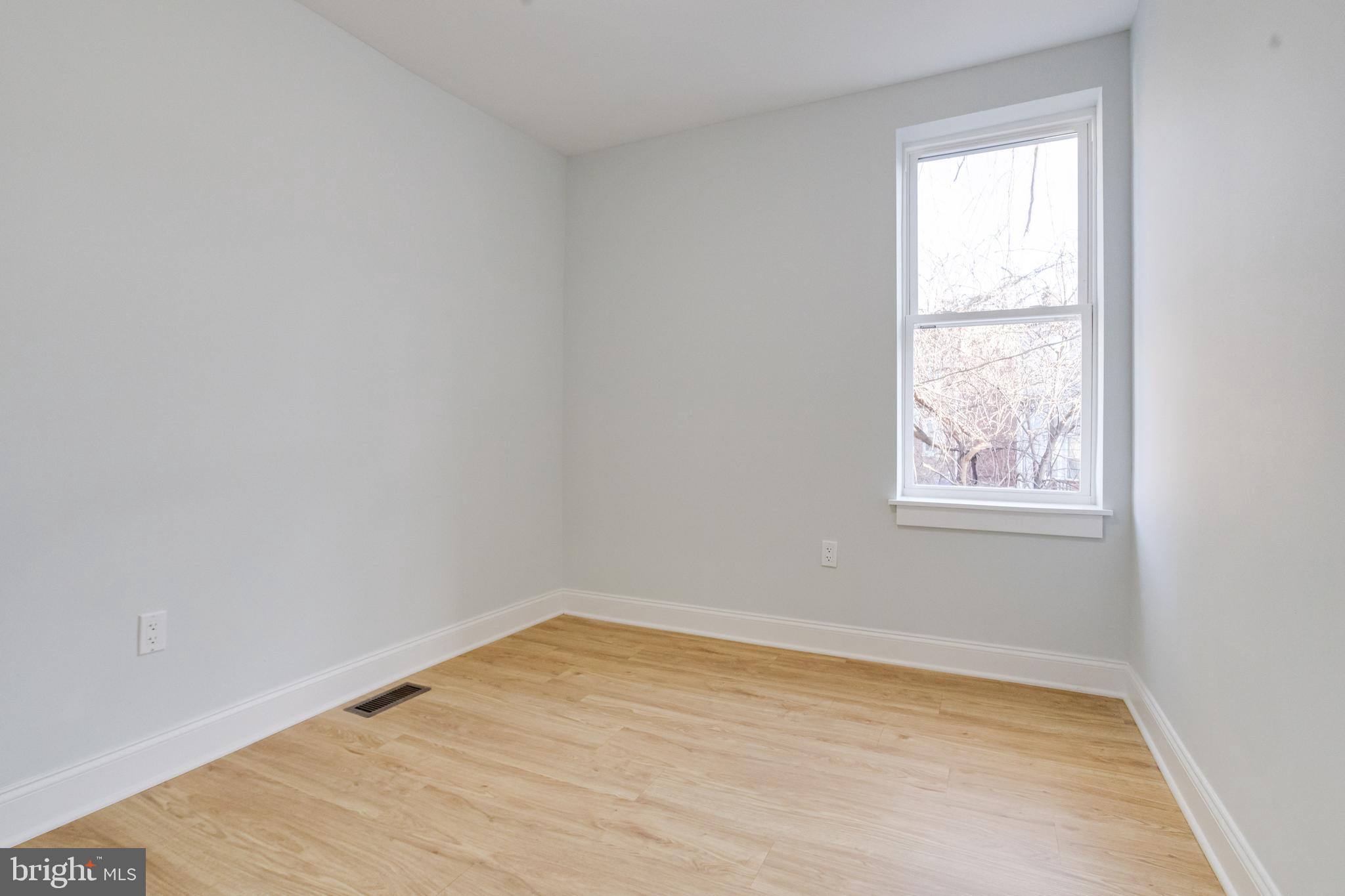 635 North Rosedale Street Baltimore, MD 21216 - Photo 44 of 64 a view of empty room with wooden floor and fan