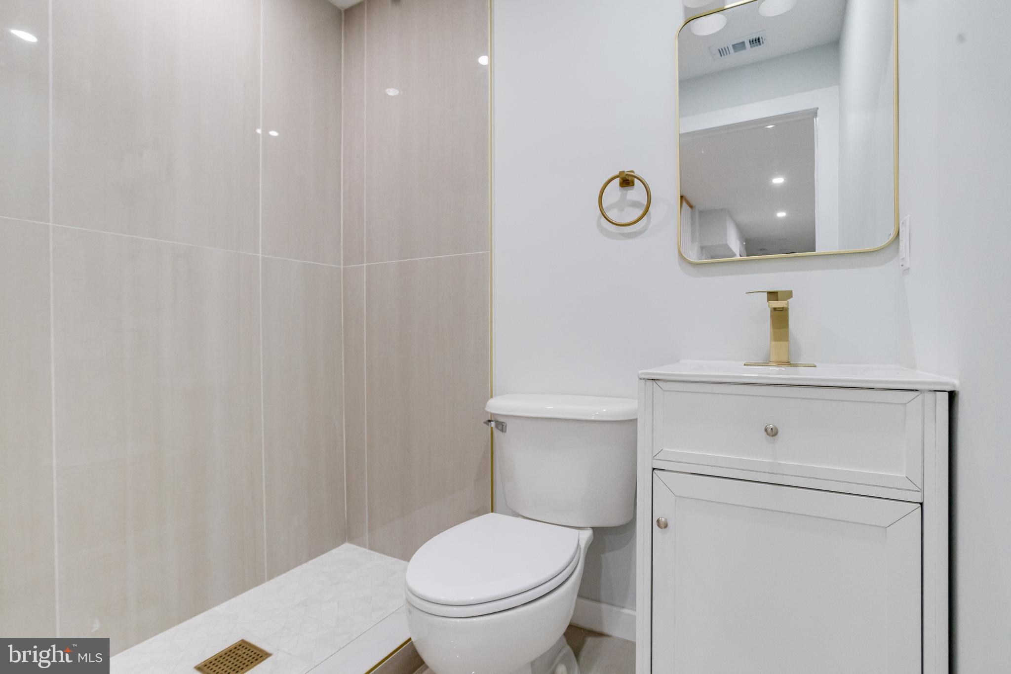 635 North Rosedale Street Baltimore, MD 21216 - Photo 48 of 64 a bathroom with a toilet a sink and mirror