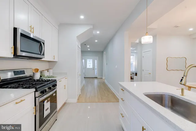 a kitchen that has a sink and a stove in it